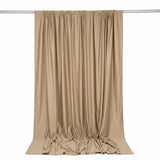 Beige satin curtain draped on a rod against a white background
