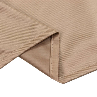 Beige ribbed knit fabric close-up with folded hem detail