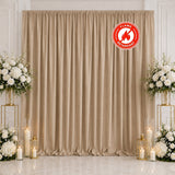 Elegant beige wedding backdrop with white floral arrangements and candles