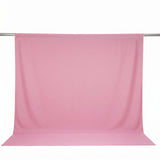 Pink fabric backdrop on a hanging rod for photography or studio use