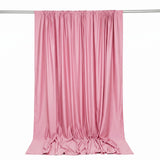 Pink satin curtain draped on a rod against a white background