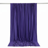 Purple satin curtain draped on a rod against a white background