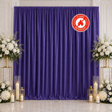 Purple flame retardant wedding backdrop with white floral arrangements and candles