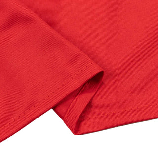 Red ribbed knit fabric close-up with folded hem detail