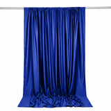 Royal blue satin curtain draped on a rod, isolated on white background