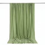 Light green satin curtain draped on a rod against white background