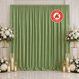 Green flame retardant curtain backdrop with white floral arrangements and candles