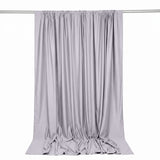 Light gray satin curtain with rod, hanging against a white background