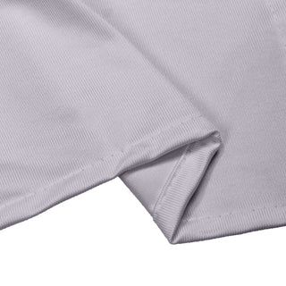 Light gray ribbed fabric close-up with folded hem and visible stitching