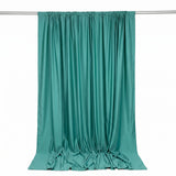 Teal satin curtain draped on a rod against a white background