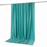 Teal draped fabric backdrop on curtain rod, isolated on white