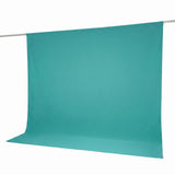 Turquoise seamless photography backdrop hanging on a support rod