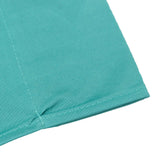 Turquoise ribbed fabric hem close-up with stitching detail