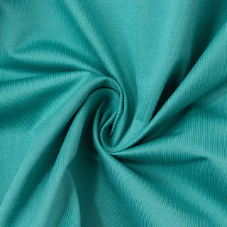 Teal knit fabric texture with swirl folds close-up#whtbkgd