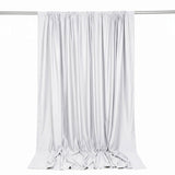 White satin curtain draped on a rod, elegant long window treatment