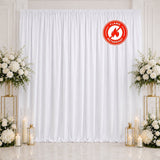 White flame retardant wedding backdrop with floral arrangements and candles