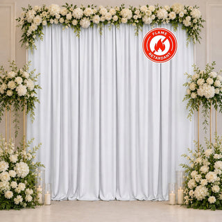 Elegant white floral wedding backdrop with fire retardant drapery and candles