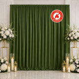 Green fire retardant curtain backdrop with white floral wedding decor and candles