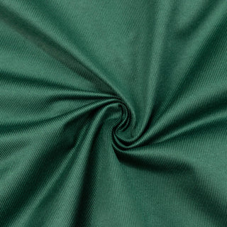 Green ribbed fabric texture swirl close-up background