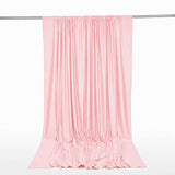 Pink satin curtain draped from a silver rod on a white background