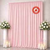 Pink flame retardant curtain backdrop with white floral arrangements and candles