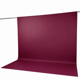 Burgundy seamless paper backdrop on studio support stand
