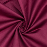Magenta fabric texture with elegant swirl folds close-up