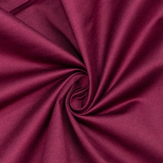 Magenta fabric texture with elegant swirl folds close-up