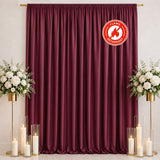 Burgundy curtain backdrop with flowers, candles, and flame retardant logo