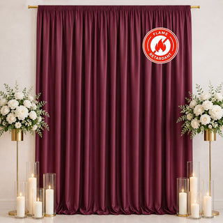 Burgundy curtain backdrop with flowers, candles, and flame retardant logo