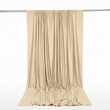Beige satin curtain drape on rod with elegant flowing folds
