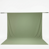 Sage green fabric backdrop on photography stand with floor sweep#whtbkgd