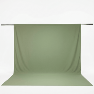 Sage green fabric backdrop on photography stand with floor sweep#whtbkgd