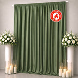 Green flame-retardant curtain backdrop with white floral arrangements and candles