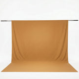 Gold seamless backdrop with floor sweep on support pole#whtbkgd