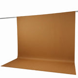 Orange pleated backdrop curtain on studio crossbar stand
