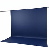 Blue seamless paper backdrop on a photography backdrop stand