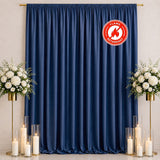 Navy blue flame retardant curtain backdrop with floral arrangements and candles