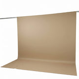 Beige seamless paper backdrop on studio photography backdrop stand