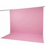 Pink seamless paper backdrop on a studio background with hanging support rod