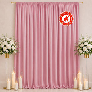 Pink flame retardant curtain backdrop with candles and white floral arrangements
