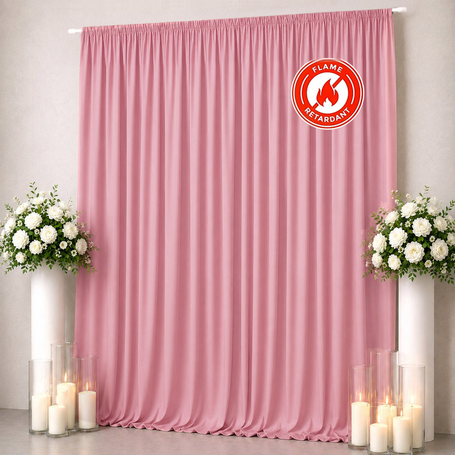 Pink flame-retardant curtain backdrop with floral arrangements and candles