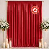 Red flame retardant curtain with floral decor and candles on a stage backdrop