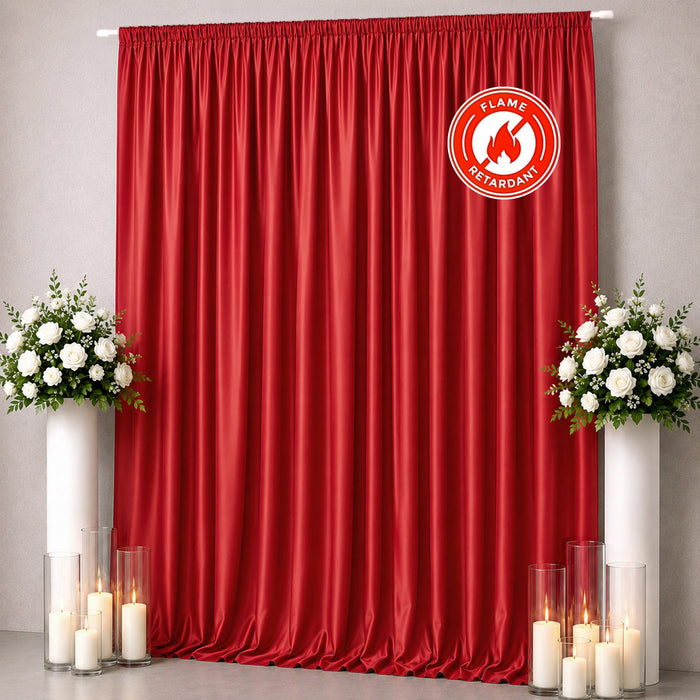 Red flame retardant curtain with white floral arrangements and candles