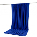 Blue satin backdrop curtain hanging on a rod with pooled fabric on the floor