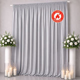 Gray flame-retardant curtain backdrop with floral arrangements and candles