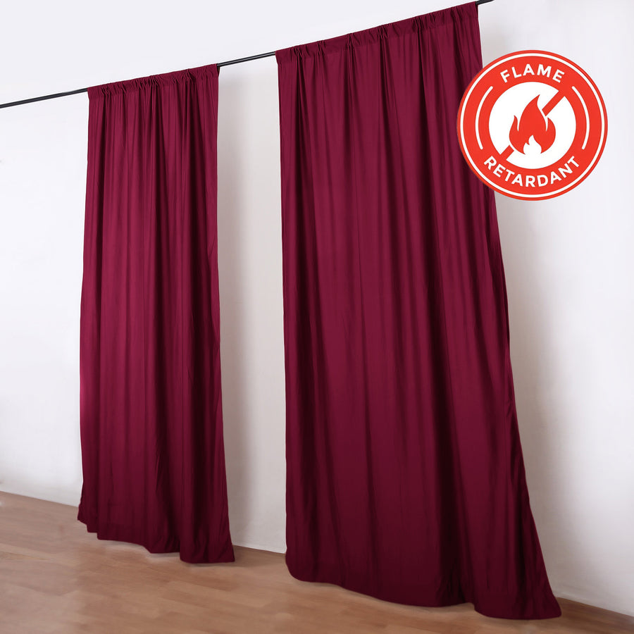 Burgundy flame retardant curtains on rod in room
