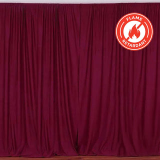 Flame-retardant burgundy curtain draped elegantly in a studio setting. #whtbkgd