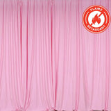 Flame-retardant pink curtain draped elegantly on a backdrop.
