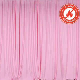 Flame-retardant pink curtain draped elegantly on a backdrop.